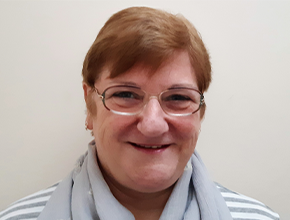 Headshot of a lady with short hair and wearing glasses